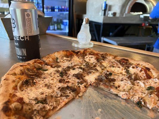 Pizza with Basil, mushrooms, and onion.