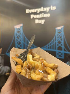 Poutine with mural in background