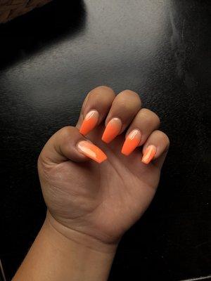 Beautiful orange ombré SNS nails.