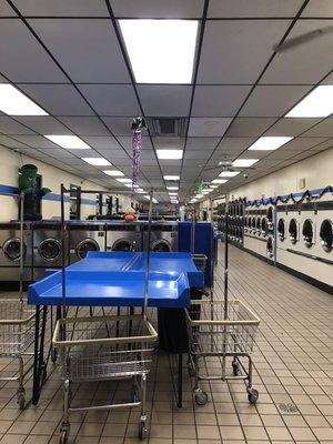 Plenty of clean folding tables and carts for your laundry