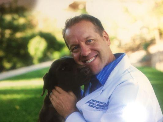 Dr. Delorefice ("Dr. Guy") with his chocolate lab.