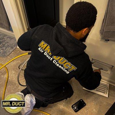 A Mr. Duct technician cleaning air ducts.