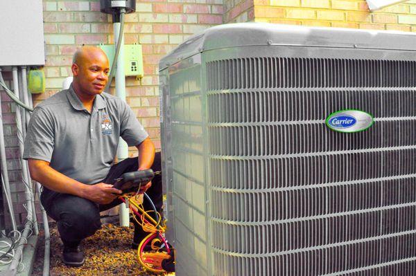 Air conditioning technician working on AC unit for a customer.