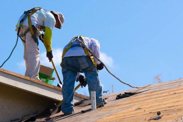 Repairing the shingles around a pipe.