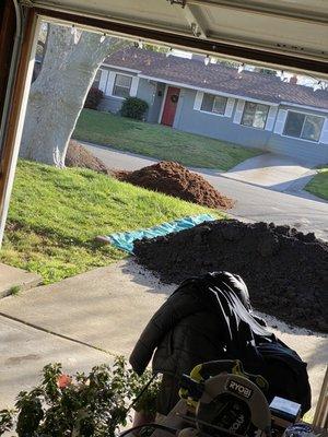 Topsoil and planters mix along with shredded cedar mulch and road base behind that for a paver walkway base