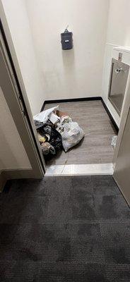 Trash being left on the floor in the trash room instead of being put in the trash chute.