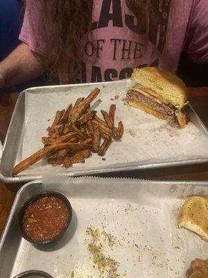 Half eaten burger and Sweet Potato Fries. Forgot to grab a photo before he dug in.