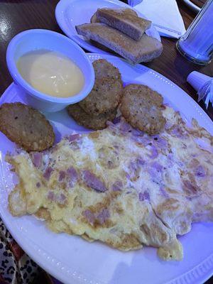 Ham and Swiss omelette with hash browns and a side of Hollandaise