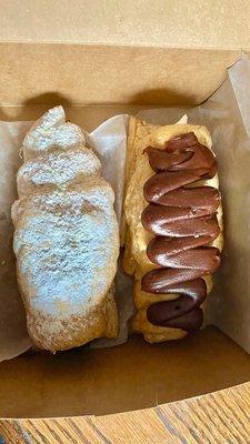 Chocolate filled cream horn, and a buttercream filled cream horn topped with chocolate.