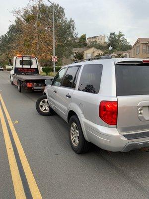 Broken down car in roadway with Quality Towing ready to tow.