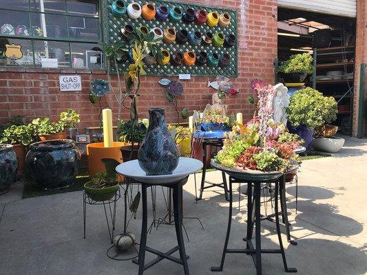 Our warehouse yard, filled with an array of pots and planting arrangements.