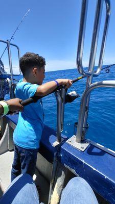 My son fishing on the boat.