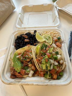 Al pastor taco, chicken taco, and rice and beans combo