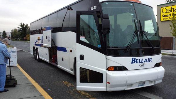 This bus has a bathroom and seatbelts. Large luggage is stowed below. Smaller items can be placed in the compartment above your seat.