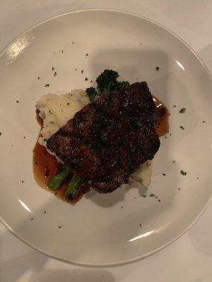 Half of the 16 oz ribeye with garlic smashed potatoes and broccolini.