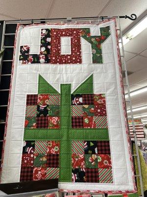 Many examples of quilts throughout the store.