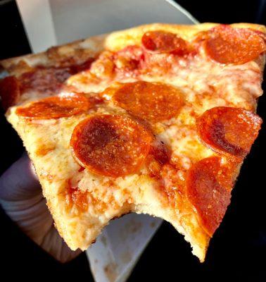 Slice of Pepperoni pizza after a bite - nice NY style thin crust and good crisp