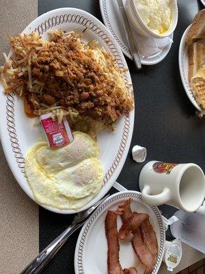 2 egg breakfast with bacon and double hash browns with cheese onion jalapeños and chili and grits.