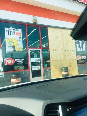 Store front of autozone all boarded up when a car drove through it. Probably wanted to run that sales guy