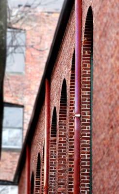 These copper downspouts and gutters add elegance to the brick Vilna Shul Temple on Beacon Hill in Boston.