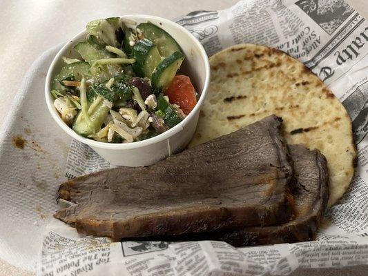 Beef, naan bread, and Greek salad