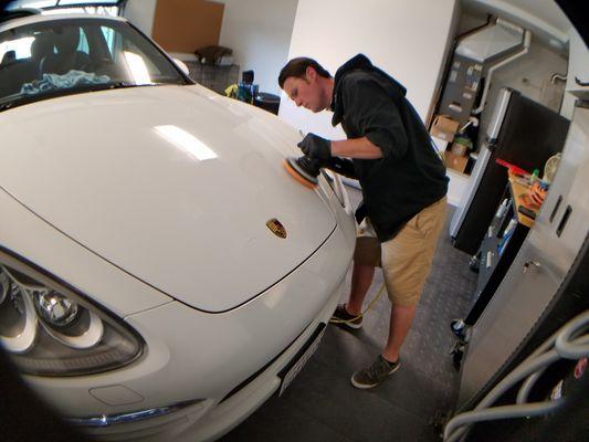 Owner and Founder Derek lay Detailing a Porsche