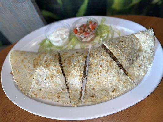 Meat Quesadilla: Any choice of meat with cheese, onion, cilantro, tomato and sour cream.