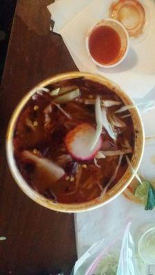 Pozole... Rich  slightly spicy red broth with plenty of pork and hominy...