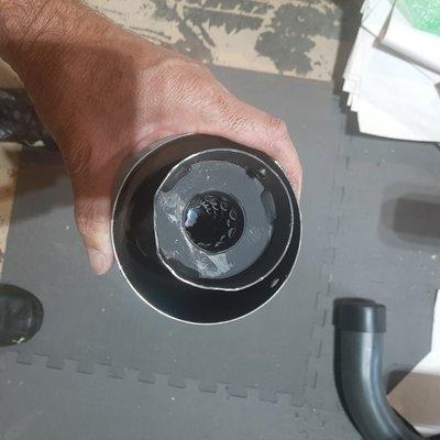 Image shows how off-center the baffle is when installed. Damage was caused while trying to remove the baffle.