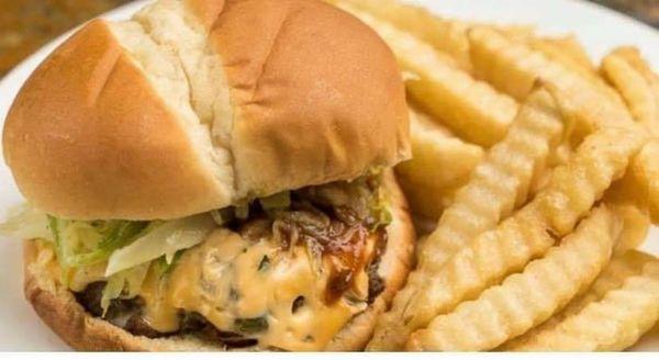 It's spicy but you can't stop eating.. Jerk burger served with fries.