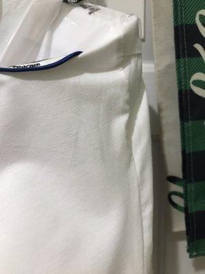 Wrinkles pressed into the shirt where sleeve joins body of shirt.