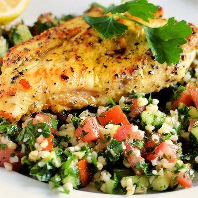 Grilled chicken breast over a bed of tabouli salad.