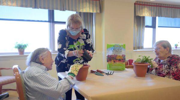 Residents participating in plant potting activity