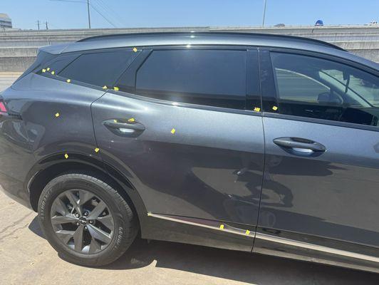 Yellow marks show the damages they documented, dust under the clear coat, scratches, residue on window panels, and chipped door handles.