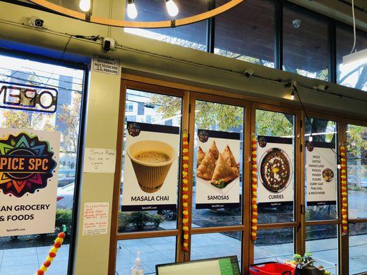 Inside the store view with food posters on beautiful glass doors.