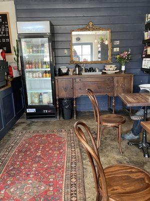 Cold beverages and cream and sugar station near more seating