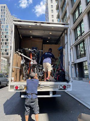 Bicycles are also loaded and secured in the truck. Everything is well organized and packed with care.