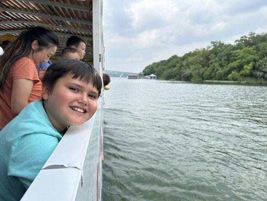 My kid enjoying our big bus going in the water.