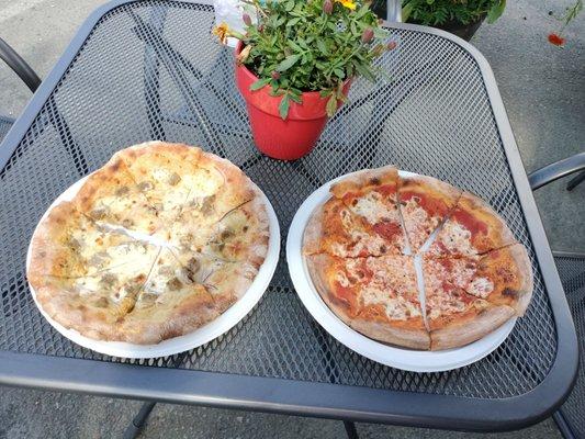 Reinbeer pizza on left ($17) and plain cheese pizza on right ($13)