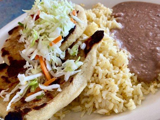 Get the pork bean cheese pupusa plate, and douse with the red and green salsas!