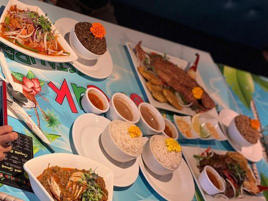 Clockwise: Fried snapper, griot, legume, stewed Turkey.