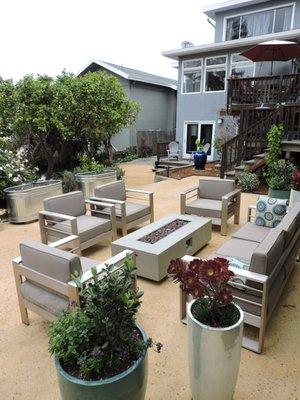 Low maintenance landscape made for entertaining and play. Golden decomposed granite, potted plants, plant and vegetable beds.  Beautiful!