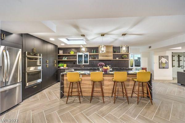 Modern Kitchen with black quartz island, black cabinetry + Backsplash/ accent wall with shelving