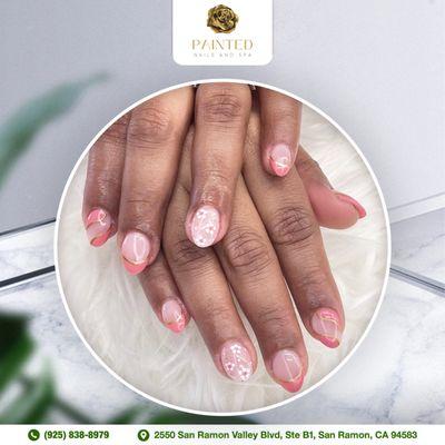 Adorn your nails with a charming pink and flower design, capturing the essence of elegant beauty.