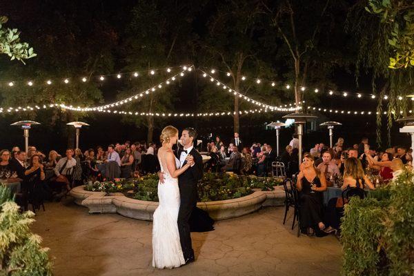 The Bride and Groom enjoying their first dance under the warm bistro lights.