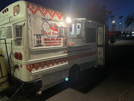 Food truck in the parking lot of Tumeric grocery store