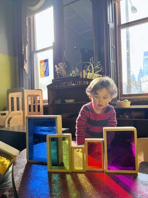 a student using Montessori materials to learn about color mixing and light.