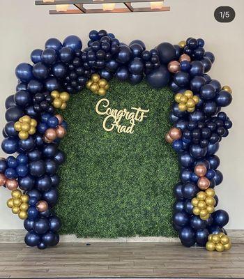 Grass wall with ballon decor on stage used for photos by PrettyNPlanned LLC