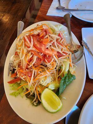 Papaya salad, as a Thai person, I asked for super spicy. She brought a sample out for me and I asked for more chilies!