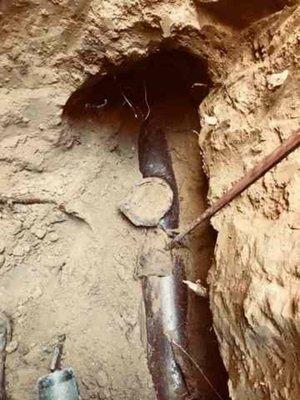 Clay sewer service with a ground rod stuck in it.